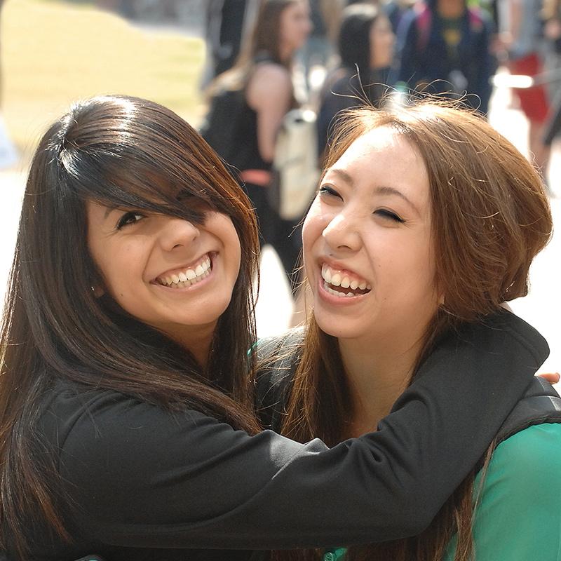 Close up of two female friends hugging